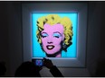 A guest takes a photo during Christie's announcement that they will offer Andy Warhol's "Shot Sage Blue Marilyn" painting of Marilyn Monroe at Christie's on March 21, 2022 in New York City. The work comes to Christie's from the Thomas and Doris Ammann Foundation Zurich and all proceeds of the sale will benefit the foundation.