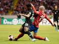 Costa Rica's Francisco Calvo, right, vies for the ball with Canada's Jonathan David during their FIFA World Cup Qatar 2022 Concacaf qualifier match at the National Stadium in San Jose, on Thursday, March 24, 2022.