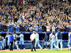 Blue Jays fans applaud their team off the field after a season-ending victory over the Orioles at Rogers Centre in Toronto, Sunday, Oct. 3, 2021.