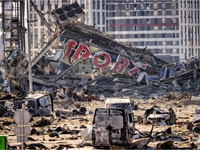 A picture taken on March 21, 2022 shows a view of the damage at  the Retroville shopping mall, a day after it was shelled by Russian forces in a residential district in the northwest of the Ukranian capital Kyiv . - At least six people were killed in the bombing. Six bodies were laid out in front of the shopping mall, according to an AFP journalist. The building had been hit by a powerful blast that pulverised vehicles in its car park and left a crater several metres wide.
