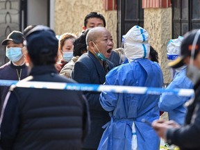 A man is tested for the COVID-19 coronavirus at a residential compound in Shanghai on March 23, 2022.