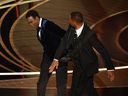 Actor Will Smith, right, slaps actor Chris Rock onstage during the 94th Oscars at the Dolby Theater in Hollywood on Sunday, March 27, 2022.