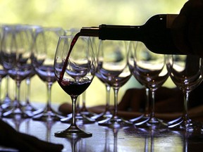 A worker at St. Supery winery pours a glass of wine for a tasting September 20, 2006 in Rutherford, Calif.