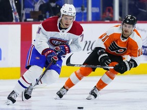 Canadiens' Jake Evans, left, tries to keep away from Philadelphia Flyers' Travis Konecny during the second period  on Sunday, March 13, 2022, in Philadelphia.