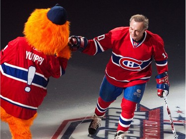 MONTREAL, QUE.: DECEMBER 5, 2010 -- Hockey legend Guy Lafleur greets the Canadiens mascot as he is introduced before his farewell game between the Anciens Canadiens and the Hall of Famers at the Bell Centre in downtown Montreal on Sunday, December 5, 2010.