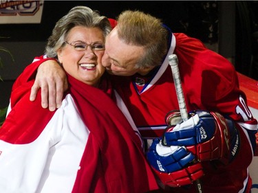 MONTREAL, QUE.: DECEMBER 5, 2010 -- Hockey legend Guy Lafleur kisses Quebec singer Ginette Reno before she sings the anthem at Lafleur's  farewell game between the Anciens Canadiens and the Hall of Famers at the Bell Centre in downtown Montreal on Sunday, December 5, 2010.
