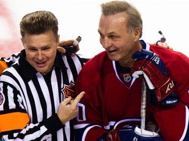 MONTREAL, QUE.: DECEMBER 5, 2010 -- Referee Kerry Fraser points at hockey legend Guy Lafleur during Lafleur's farewell game between the Anciens Canadiens and the Hall of Famers at the Bell Centre in downtown Montreal on Sunday, December 5, 2010.