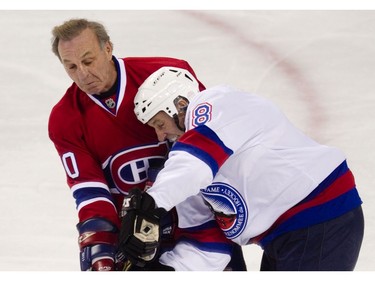 MONTREAL, QUE.: DECEMBER 5, 2010 -- Hockey legend Guy Lafleur (L) collides with Hall of Famer Denis Savard (R) during Lafleur's farewell game between the Anciens Canadiens and the Hall of Famers at the Bell Centre in downtown Montreal on Sunday, December 5, 2010.