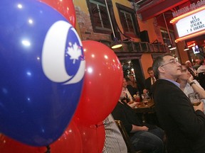 People at a Conservative gathering in Quebec City watch election night coverage on May 2, 2011. If federal Conservatives can help unite Quebec anglophones and francophones, that would boost their prospects of electoral success, Richard W. Smith says.