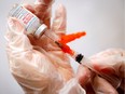 FILE PHOTO: A healthcare worker prepares a syringe with the Moderna COVID-19 vaccine at a pop-up vaccination site in Manhattan in New York City, New York, U.S., January 29, 2021. REUTERS/Mike Segar/File Photo