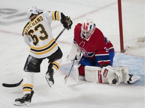 Canadiens goaltender Jake Allen makes a glove save on Bruins' Brad Marchand during first-period action Monday night at the Bell Centre. Marchand would score two goals on the night, including the OT winner.