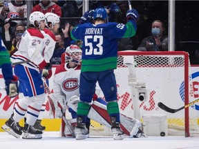 The Canucks’ Bo Horvat celebrates Brock Boeser’s goal against Canadiens goalie Sam Montembeault during second period Wednesday night in Vancouver.