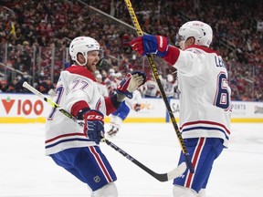 Canadiens' Brett Kulak (77) and Artturi Lehkonen (62) celebrate a goal against the Edmonton Oilers during third period NHL action in Edmonton on Saturday, March 5, 2022.