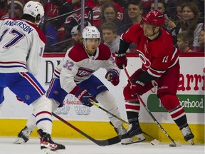 Carolina Hurricanes centre Max Domi (13) holds onto the puck against Montreal Canadiens centre Rem Pitlick (32) during the second period at PNC Arena on March 31, 2022.