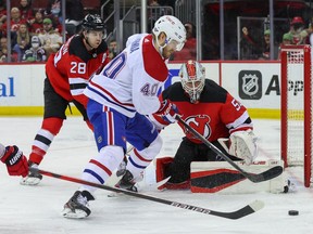 Canadiens' Joel Armia (40) plays the puck after a save by New Jersey Devils goaltender Nico Daws at the Prudential Center on Sunday, March 27, 2022, in Newark, N.J.