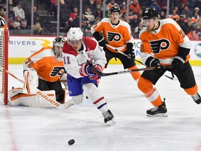 Canadiens' Brendan Gallagher (11) and Flyers defenceman Rasmus Ristolainen (70) battle for the puck during the first period at Wells Fargo Center on March 13, 2022, in Philadelphia.