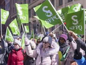 Quebec civil servants demonstrate in downtown Montreal during a one-day strike on Wednesday, March 30, 2022.