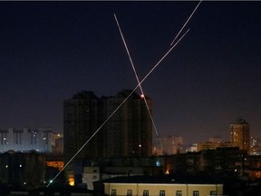 Tracers are seen in the night sky as Ukrainian servicemen fire on the drone as Russia's attack on Ukraine continues, in Kyiv, Ukraine March 14, 2022. REUTERS/Gleb Garanich