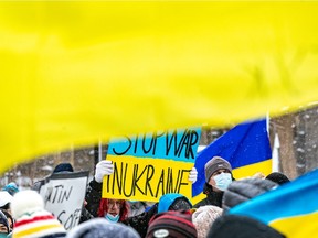 Demonstrators in Place du Canada rally against Russia's invasion of Ukraine.