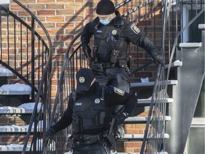 Montreal police officers holster their weapons after an intervention. "Everyone, including municipal police chiefs, agrees that the funding model needs to be overhauled," says Roberson Edouard, lead author of a report on policing. "Everyone realizes that there is a mismatch between where we are putting the money and where the needs are."