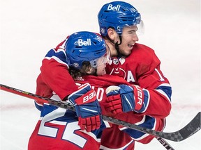 The Canadiens’ Cole Caufield (22) is congratulated by teammate Nick Suzuki after scoring goal against the St. Louis Blues during game at the Bell Centre on Feb. 17, 2022.