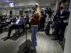 Pointe-Claire resident Geneviève Lussier speaks as Fairview Cadillac's Brian Salpeter (right) stands and listens in during a special meeting at city hall on Tuesday.