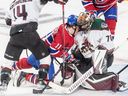 Montreal Canadiens right wing Brendan Gallagher (11) is driven into the shoulder of Arizona Coyotes goaltender Karel Vejmelka at the Bell Center in Montreal on March 15, 2022.