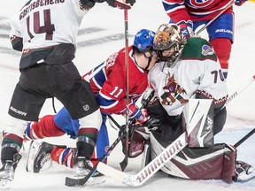 Montreal Canadiens right wing Brendan Gallagher (11) is driven into the shoulder of Arizona Coyotes goaltender Karel Vejmelka at the Bell Centre in Montreal on March 15, 2022.