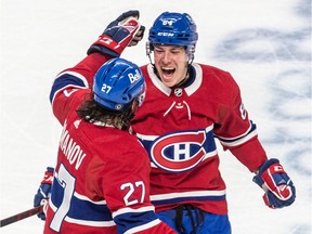 Montreal Canadiens defenceman Alexander Romanov congratulates fellow blue-liner Corey Schueneman on Schueneman's goal during third period at the Bell Centre in Montreal on March 17, 2022.