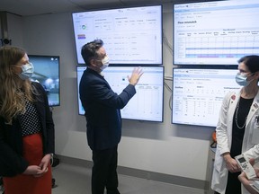 Dan Gabay, assistant executive director for the CIUSSS West-Central Montreal, talks about the new command centre with Erin Cook, left, associate director for quality, innovation and performance, and Dr. Shannon Fraser, chief of general surgery at the Jewish General Hospital, on March 31, 2022.