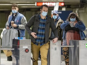Transit users wear masks in the Peel métro station in spring 2022. The mask mandate on public transit will end in mid-June.