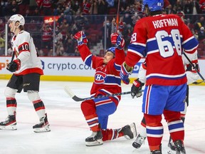 Montreal Canadiens' Brendan Gallagher celebrates his goal  during first period of National Hockey League game against the Ottawa Senators in Montreal Tuesday, April 5, 2022.  Teammate Mike Hoffman moves in to congratulate Gallagher while Sens Alex Formenton heads to the bench.