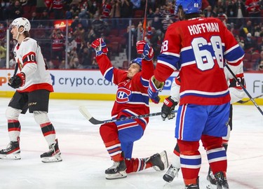 Montreal Canadiens' Brendan Gallagher celebrates his goal  during first period of National Hockey League game against the Ottawa Senators in Montreal Tuesday, April 5, 2022.  Team-mate Mike Hoffman moves in to congratulate Gallagher while Sens Alex Formenton heads to the bench.