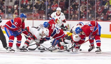 Montreal Canadiens, from left, Paul Byron, Christian Dvorak and Joel Armia get tied up with Ottawa Senators' Brady TTkachuk and Josh Norris on a face-off during second period of National Hockey League game in Montreal Tuesday, April 5, 2022.