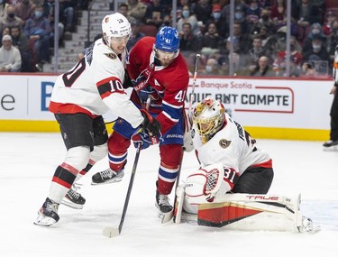 Ottawa Senators' goalie Anton Forsberg makes a save as teammate Alex Formenton ties up Montreal Canadiens' Paul Byron during third period of National Hockey League game in Montreal Tuesday, April 5, 2022.