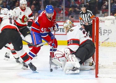 Montreal Canadien's Joel Armia can't control loose puck in front of Ottawa Senators goalie Anton Forsberg during first period of National Hockey League game in Montreal Tuesday, April 5, 2022.