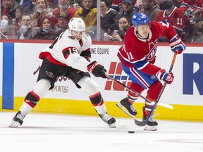 Drake Batherson lifts Brendan Gallagher's stick during the third period of the Montreal Canadiens' game against the Ottawa Senators at the Bell Centre on Tuesday April 5, 2022.