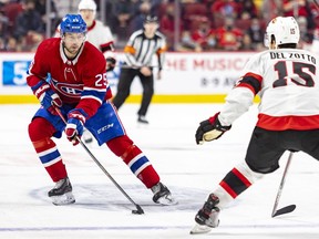 Montreal Canadiens' Ryan Poehling carries the puck while being watched by Ottawa Senators Michael Del Zotto during third period in Montreal on April 5, 2022.