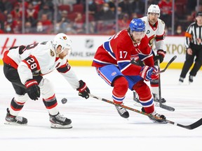 Montreal Canadiens Josh Anderson has the puck knocked off his stick by Ottawa Senators Connor Brown during first period of National Hockey League game in Montreal Tuesday April 5, 2022.