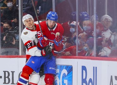 Montreal Canadiens' Ryan Poehling is checked by Ottawa Senators' Dylan Gambrell during first period of National Hockey League game in Montreal Tuesday, April 5, 2022.