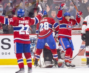 Montreal Canadiens' Brendan Gallagher turns to celebrate with Cole Caufield after Caufield's goral against the Ottawa Senators during second period of National Hockey League game in Montreal Tuesday, April 5, 2022.