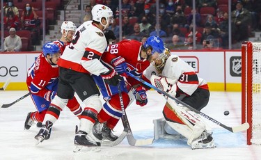 Montreal Canadiens' Brendan Gallagher, left, shoots the puck past Ottawa Senators goalie Anton Forsberg as Habs' Mike Hoffman provides a screen behind Senators' Artem Zub during first period of National Hockey League game in Montreal Tuesday, April 5, 2022.