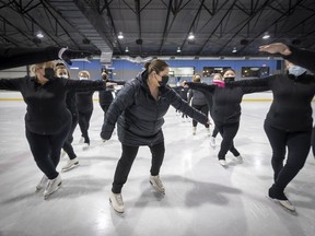 Ariane Beland, coach of an adult figure skating club, gives directions to some members in St-Lazare last Friday.