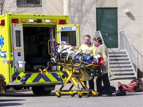 Paramedics wheel a resident out of CHSLD Herron in Dorval in the spring of 2020.