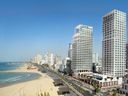 The David Kempinski Tel Aviv (right-side tower) opens this month on the Mediterranean shore.