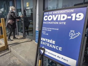 A woman enters the COVID-19 vaccination clinic on Parc Ave. in Montreal on Monday April 11, 2022.