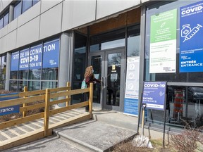 A woman enters the COVID-19 vaccination clinic on Parc Ave. in Montreal on Monday April 11, 2022.