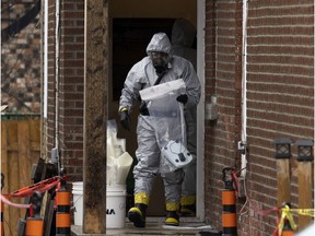 RCMP officers remove evidence bags from a suspected drug lab in Montreal on Wednesday, April 13, 2022.