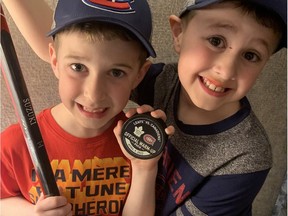 Young Habs fans Hunter Beauparlant, left, and brother Jaxen with a stick and puck given to Hunter by Canadiens centre Nick Suzuki before a game against the Maple Leafs in Toronto on April 9, 2022.