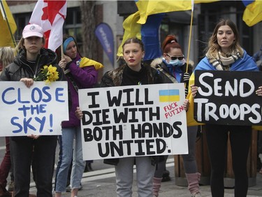 People take part in a rally Saturday, April 16, 2022, in Old Montreal in support of Ukraine.